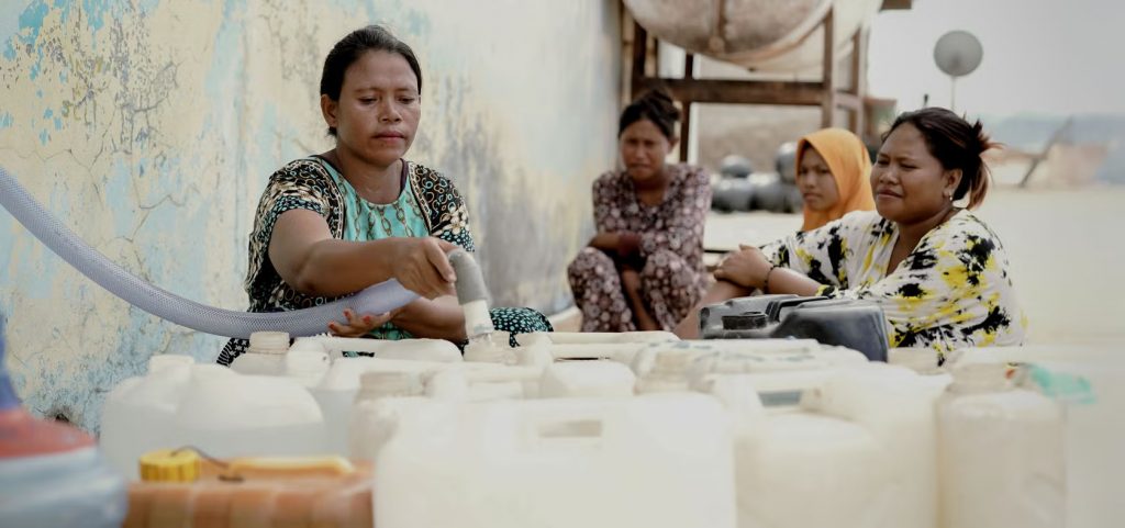 Photograph of women bottling water in Indonesia.